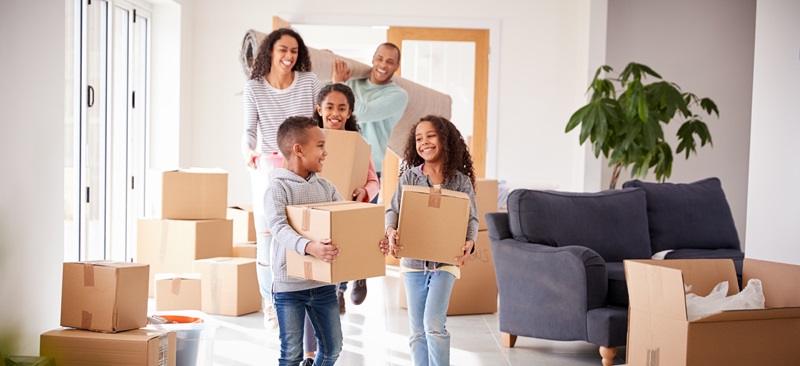 happy-family-moving-into-home-with-boxes