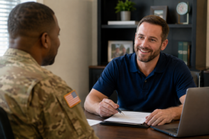A veteran in military uniform meets with a loan officer in an office to discuss home loan documents.